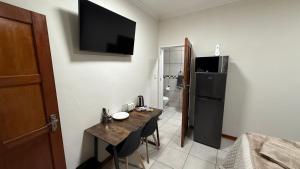 a small kitchen with a table and a refrigerator at The Willows in Polokwane