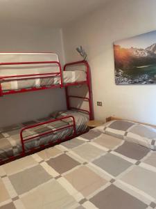 a bedroom with two bunk beds and a tiled floor at Il Rifugio di Marcella in Challand Saint Anselme