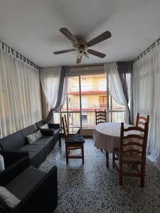 a living room with a couch and a ceiling fan at Faro28 in Valencia