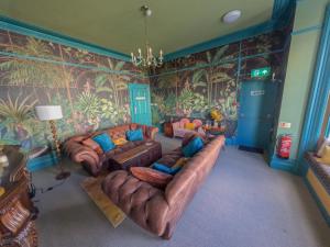 a living room with two couches and a mural at The Sheldon B&B in Eastbourne +38 photos