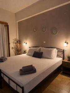 a bedroom with a large bed with two towels on it at Kokkala Guestrooms in Kokkala
