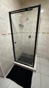 a shower with a glass door in a bathroom at The Willows in Polokwane +44 photos