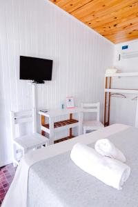 a bedroom with a bed and a tv on the wall at La Posada del Abra in Tigre