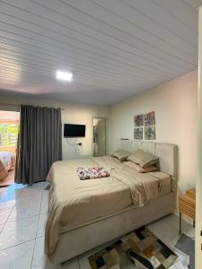 a bedroom with a large bed in a room at Sitio encantos do vale Casa in Major +48 photos