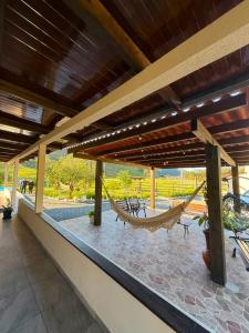 a hammock on the roof of a house at Sitio encantos do vale Casa in Major
