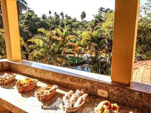 a view from a balcony with baskets of bread at Pousada Coqueiro Verde in Mateus Leme