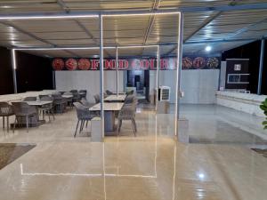 a restaurant with tables and chairs and a sign that reads the food court at Hotel Keshar Palace Shani Shingnapur in Sonai