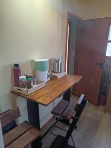 a wooden table in a room with two chairs at Alojamiento Adonai in Tolhuin