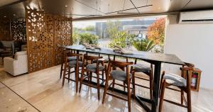 a kitchen with a bar with stools at La Posada Hotel y Suites in San Luis Potosí +27 photos