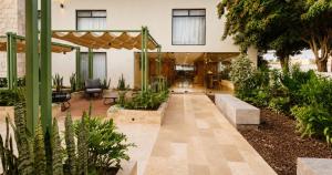 a courtyard in a building with plants at La Posada Hotel y Suites in San Luis Potosí