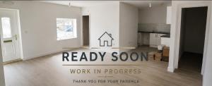 an empty living room with a sign that says ready soon work in progress at The Ashington Collection in Ashington