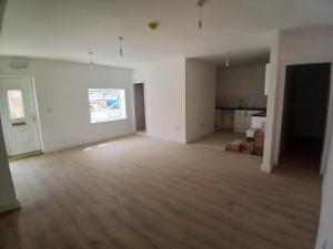 an empty living room with a hard wood floor at The Ashington Collection in Ashington