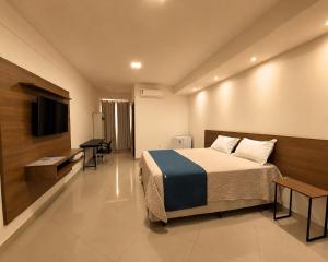 ein Hotelzimmer mit Bett und Flachbildfernseher in der Unterkunft Hotel Skalla - MELHOR CUSTO BENEFICIO in Teixeira de Freitas + 61 Fotos