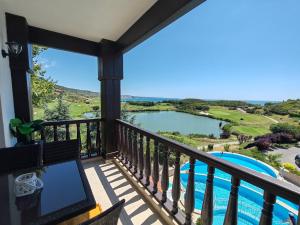 a balcony with a view of a pool at Thracian Cliffs Owners Apartments in Kavarna