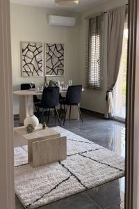 a living room with a table and a dining room at Bistro 49 Luxury suites in Katerini +11 photos