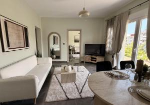 a living room with a couch and a table at Bistro 49 Luxury suites in Katerini