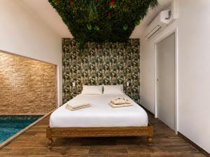 a bedroom with a bed with two towels on it at Eaux Spa Rive Droite in Rouen +45 photos