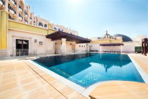 a large swimming pool in the middle of a building at Legend Palace Hotel in Macau