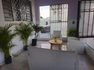 a balcony with a table and chairs and plants at Casa el Monte in Valladolid