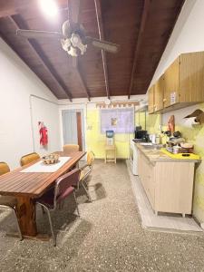a kitchen with a table and chairs in a room at Villa Valeria in General Acha