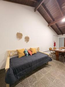 a bed with pillows on it in a room at Villa Valeria in General Acha