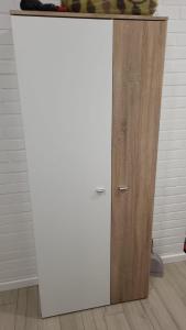 a white cabinet with a wooden door in a room at Studio apartman Mara in Imotski