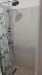 a shower with a shower curtain in a bathroom at Studio apartman Mara in Imotski