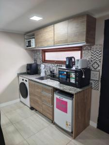 a small kitchen with a sink and a dishwasher at Departamentos Turísticos MD in El Calafate +35 photos
