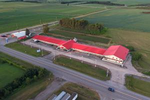 an overhead view of a building with red roofs next to a highway at Skye Hotel Ridgetown in Ridgetown +6 photos