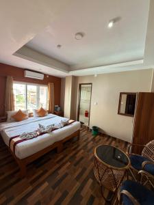 a bedroom with a large bed and a table at Kathmandu Metro Boutique Hotel in Kathmandu