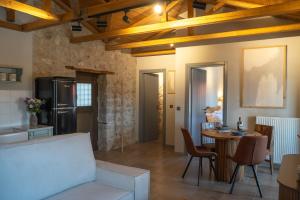 a kitchen and living room with a table and a couch at Penelope Suites With View Meteora in Kalabaka