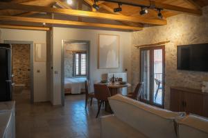 a living room with a couch and a table at Penelope Suites With View Meteora in Kalabaka