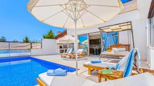 a villa with a swimming pool and a patio at Secluded Sea-View Family Escape Villa Bella 3 Lale in Üzümlü