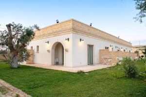 a large white building with a large doorway at Masseria Pozzelle in Otranto