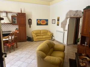 a living room with a couch and a table at La Via delle Rose in Alimena +8 photos