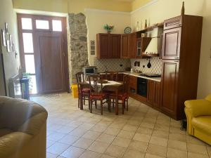 a kitchen with a table and chairs and a dining room at La Via delle Rose in Alimena