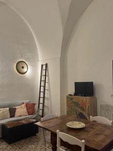 a living room with a table and a couch at Ca Salentu in Galatone