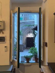 a window view of a hallway with potted plants at Ca Salentu in Galatone
