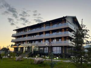 a large building with a lot of windows at Тынчтык Отель in Chon-Sary-Oy