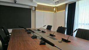 a large conference room with a long table with microphones at Тынчтык Отель in Chon-Sary-Oy +26 photos
