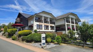 a building with a sign in front of it at Hotel Magdalenenhof inklusive MeineCardPlus in Willingen