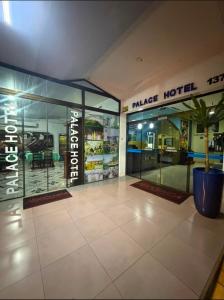 a market hotel with a potted plant in front of it at Visk Palace Hotel e Restaurante in Foz do Iguaçu