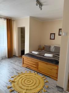 a bedroom with a large bed and a large rug at Willa Wojciechówka in Kościelisko