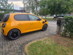 a small yellow car is plugged into a meter at Apartment Milena in Maribor