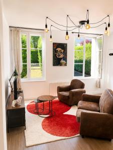 a living room with a couch and a red rug at Brick - Loft design avec parking privé in Saint-Désir