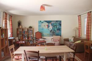 a living room with a wooden table and chairs at Casa Verità in San Daniele del Friuli