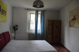 a bedroom with a bed and a window at Casa Verità in San Daniele del Friuli