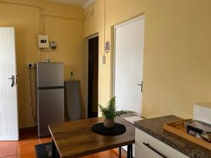 a kitchen with a table and a refrigerator at Dube Villa in KwaDukuza
