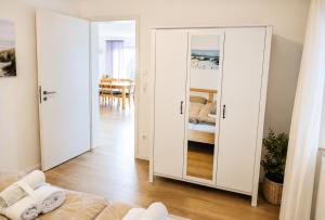 a bedroom with a large mirror in a room at Panoramablick mit Premium-Wanderwegen vor der Haustür in Albstadt +60 photos