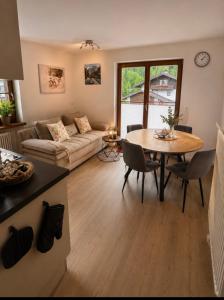 a living room with a table and a couch at Appartement Wanneck in Biberwier +29 photos